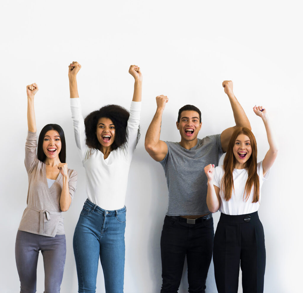 Group of happy young people raising their arms.